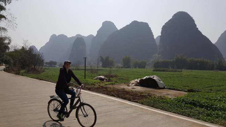 riding bicycle bike in Yangshu China at 10 Mile Gallery. Karst mountain and farm