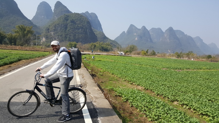 Farm and karst mountains with bike on road in Yangshuo China